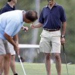 President Barack Obama, right, reacts after a putt at Mid-Pacific County Club in Kailua, Hawaii, Thursday, Dec. 31, 2009. (AP Photo/Chris Carlson)