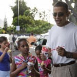 President Barack Obama, with daughter Sasha Obama, 8, center, and other family friends, enjoy shave ice at Island Snow in Kailua, Hawaii Friday, Jan. 1, 2010. The Obamas are in Hawaii for the holidays.(AP Photo/Alex Brandon)
