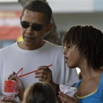 President Barack Obama shares shave ice with his daughter Malia Obama, 11, at Island Snow in Kailua, Hawaii Friday, Jan. 1, 2010. The Obamas are in Hawaii for the holidays. (AP Photo/Alex Brandon)