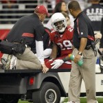 Arizona Cardinals cornerback Dominique Rodgers-Cromartie is loaded onto a cart after injuring his knee during the first half on an NFL football game against the Green Bay Packers on Sunday, Jan. 3, 2010 in Glendale, Ariz. (AP Photo/Matt York)