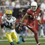 Green Bay Packers cornerback Charles Woodson (21) intercepts a pass intended for Arizona Cardinals wide receiver Larry Fitzgerald, for a touchdown during the first half on an NFL football game Sunday, Jan. 3, 2010, in Glendale, Ariz. (AP Photo/Paul Connors)