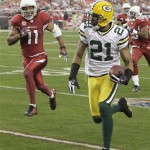 Green Bay Packers' Charles Woodson (21) returns an interception for a touchdown as Arizona Cardinals' Larry Fitzgerald (11) tries to chase down Woodson down in the second quarter of an NFL football game Sunday, Jan. 3, 2010, in Glendale, Ariz. (AP Photo/Ross D. Franklin)