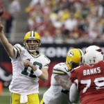 Green Bay Packers' Aaron Rodgers, left, throws a pass as Packers' Daryn Colledge (73) blocks Arizona Cardinals' Jason Banks (79) in the second quarter of an NFL football game Sunday, Jan. 3, 2010, in Glendale, Ariz. (AP Photo/Ross D. Franklin)