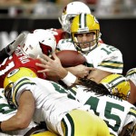 Green Bay Packers quarterback Aaron Rodgers (12) scores a touchdown during the first half on an NFL football game against the Arizona Cardinals on Sunday, Jan. 3, 2010, in Glendale, Ariz. (AP Photo/Matt York)