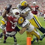 Arizona Cardinals' LaRod Stephens-Howling (36) is stopped short of the end zone by Green Bay Packers' Tramon Williams (38), Brandon Chillar (54) and Atari Bigby (20) during the first half of an NFL wild-card playoff football game Sunday, Jan. 10, 2010, in Glendale, Ariz. (AP Photo/Ross D. Franklin)