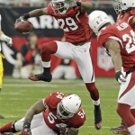 Arizona Cardinals' Dominique Rodgers-Cromartie (29) jumps over a teammate after intercepting a pass during the first half of an NFL wild-card playoff football game against the Green Bay Packers on Sunday, Jan. 10, 2010, in Glendale, Ariz. (AP Photo/Ross D. Franklin)