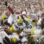 Green Bay Packers quarterback Aaron Rodgers (12) sneaks into the end zone for a touchdown during the first half of an NFL wild-card playoff football game against the Arizona Cardinals on Sunday, Jan. 10, 2010, in Glendale, Ariz. (AP Photo/Ross D. Franklin)