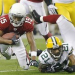 Arizona Cardinals' Steve Breaston (15) is tripped by by Green Bay Packers' Charles Woodson (21) after a catch during the first half of an NFL wild-card playoff football game Sunday, Jan. 10, 2010, in Glendale, Ariz. (AP Photo/Matt York)