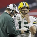 Green Bay Packers coach Mike McCarthy talks to quarterback Aaron Rodgers during the first half of an NFL wild-card playoff football game against the Arizona Cardinals on Sunday, Jan. 10, 2010, in Glendale, Ariz. (AP Photo/Ross D. Franklin)