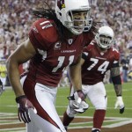 Arizona Cardinals' Larry Fitzgerald (11) reacts after catching a touchdown pass during the second half of an NFL wild-card playoff football game against the Green Bay Packers on Sunday, Jan. 10, 2010, in Glendale, Ariz. (AP Photo/Ross D. Franklin)