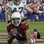 Arizona Cardinals' Larry Fitzgerald (11) catches a touchdown pass in front of Green Bay Packers' Matt Giordano (47) during the second half of an NFL wild-card playoff football game Sunday, Jan. 10, 2010, in Glendale, Ariz. (AP Photo/Ross D. Franklin)