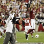 Arizona Cardinals' Larry Fitzgerald celebrates after the Cardinals defeated the Green Bay Packers 51-45 in overtime in an NFL wild-card playoff football game Sunday, Jan. 10, 2010, in Glendale, Ariz. (AP Photo/Paul Connors)