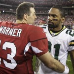 Arizona Cardinals quarterback Kurt Warner (13) talks to Green Bay Packers' Charles Woodson after the Cardinals defeated the Packers 51-45 in overtime in an NFL wild-card playoff football game Sunday, Jan. 10, 2010, in Glendale, Ariz. (AP Photo/Ross D. Franklin)