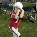 Korver Demma, 5, of Chandler, Ariz., tries to catch a football before the first half of an NFL wild-card playoff football game between the Arizona Cardinals and Green Bay Packers, Sunday, Jan. 10, 2010, in Glendale, Ariz. (AP Photo/Paul Connors)