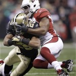 Arizona Cardinals safety Adrian Wilson (24) takes down New Orleans Saints running back Reggie Bush (25) during the first quarter of an NFL football divisional playoff game in New Orleans, Saturday, Jan. 16, 2010. (AP Photo/David J. Phillip)