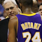 Los Angeles Lakers head coach Phil Jackson talks with Kobe Bryant (24) during a timeout against the Phoenix Suns during the first quarter of an NBA basketball game Friday, March 12, 2010, in Phoenix. (AP Photo/Matt York)