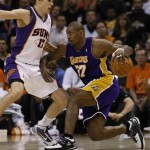 Los Angeles Lakers' Ron Artest, right, drives against Phoenix Suns' Louis Amundson during the second half of an NBA basketball game Friday, March 12, 2010, in Phoenix. The Lakers won 102-96. (AP Photo/Matt York)