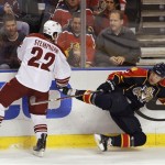 Phoenix Coyotes' Lee Stempniak (22) knocks Florida Panthers' Keith Ballard (2) to the ice during the first period of an NHL hockey game in Sunrise, Fla., Thursday, March 18, 2010. (AP Photo/J Pat Carter)
