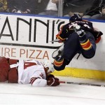 Florida Panthers' Nick Tarnasky, right,flies over Phoenix Coyotes' Daniel Winnik (34) as they fight for the puck during second-period NHL hockey game action in Sunrise, Fla. Thursday, March 18, 2010. (AP Photo/J Pat Carter)