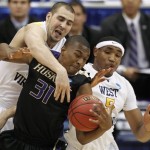 Washington's Elston Turner (31) tries control the ball as West Virginia's Cam Thoroughman, left, and Kevin Jones defend during the first half of a semifinal in the East Regional of the NCAA college basketball tournament Thursday, March 25, 2010, in Syracuse, N.Y. (AP Photo/Mike Groll)