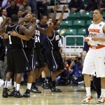 As Butler celebrates, Syracuse's Brandon Triche, right, leaves the floor at the end of an NCAA West Regional semifinal college basketball game in Salt Lake City, Thursday, March 25, 2010. Butler won 63-59. (AP Photo/Colin E. Braley)
