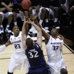 Kansas State's Dominique Sutton, left and Wally Judge, right, battle with Xavier's Kenny Frease for a loose ball in the first half of an NCAA West Regional semifinal college basketball game in Salt Lake City, Thursday, March 25, 2010. (AP Photo/Steve C. Wilson)