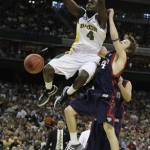 Baylor's Quincy Acy, left, dunks against Saint Mary's Matthew Dellavedova during the second half of an NCAA South Regional semifinal college basketball game in Houston, Friday, March 26, 2010. Baylor defeated Saint Mary's 72-49. (AP Photo/Eric Gay)