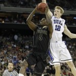 Purdue's Keaton Grant, left, puts up a shot against Duke's Kyle Singler during the first half of an NCAA South Regional semifinal college basketball game in Houston, Friday, March 26, 2010. (AP Photo/Eric Gay)