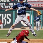 Milwaukee Brewers shortstop Craig Counsell, top, leaps to avoid the slide of Arizona Diamondbacks Chris Young after forcing him at second on the front end of a double play in the first inning of a Cactus League spring training baseball game in Tucson, Ariz., on Sunday, March 28, 2010. Arizona's Stephen Drew was out at first. (AP Photo/Ed Andrieski)