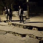 Men stand next to cracks on a street in Mexicali, Mexico, early Monday, April 5, 2010, after a powerful earthquake struck. The quake shook buildings in Mexico, California and Arizona. (AP Photo/Guillermo Arias)