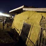 A man walks near his house after a powerful earthquake hit Mexicali, Mexico, early Monday, April 5, 2010. The earthquake swayed buildings from Los Angeles to Tijuana. (AP Photo/Guillermo Arias)