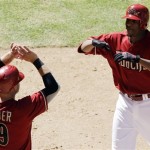 Arizona Diamondbacks pitcher Edwin Jackson, right, celebrates his two-run home run against the Pittsburgh Pirates with teammate Chris Snyder (19) in the fourth inning of a baseball game Sunday, April 11, 2010, in Phoenix. The Diamondbacks defeated the Pirates 15-6. (AP Photo/Ross D. Franklin)