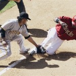 Arizona Diamondbacks' Justin Upton, right, slides safely into third base ahead of the tag by Pittsburgh Pirates' Delwyn Young in the fourth inning of a baseball game Sunday, April 11, 2010, in Phoenix. Upton advanced to third base on a single by teammate Adam LaRoche and the Diamondbacks defeated the Pirates 15-6. (AP Photo/Ross D. Franklin)