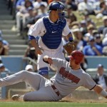 Arizona Diamondbacks' Chris Snyder is forced at home on a bases-loaded base hit as Los Angeles Dodgers catcher Russell Martin watches the play in the fifth inning in the Dodgers' home opener baseball game Tuesday, April 13, 2010 in Los Angeles. (AP Photo/Reed Saxon)