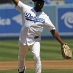 Musician will.i.am of the Black Eyed Peas throws out the ceremonial first pitch before the Los Angeles Dodgers-Arizona Diamondbacks in the Dodgers' home opener baseball game Tuesday, April 13, 2010 in Los Angeles. (AP Photo/Reed Saxon)