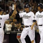 San Diego Padres Chase Headley, center, and Kyle Blanks, right, are congratulated by teammate Jerry Hairston, left, after scoring during the seventh inning of a baseball game against the Arizona Diamondbacks Saturday, April 17, 2010 in San Diego. The Padres won 5-0. (AP Photo/Denis Poroy)