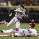 St. Louis Cardinals shortstop Brendan Ryan, front, avoids the slide by Arizona Diamondbacks' Chris Snyder, rear, after Ryan forced Snyder out on a fielder's choice in the second inning of a baseball game Monday, April 19, 2010, in Phoenix. (AP Photo/Paul Connors)