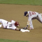 Arizona Diamondbacks' Gerardo Parra, left, dives safely back to second base ahead of the tag attempt by St. Louis Cadinals second baseman Skip Schumaker, right, after Parra overran the base in the fourth inning of a baseball game Monday, April 19, 2010, in Phoenix. (AP Photo/Paul Connors)
