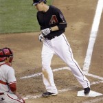 Arizona Diamondbacks' Kelly Johnson, right, steps on home plate in front of Philadelphia Phillies catcher Carlos Ruiz, left, after hitting a two-run home run off Phillies pitcher Nelson Figueroa in the fifth inning of a baseball game Saturday, April 24, 2010, in Phoenix. (AP Photo/Paul Connors)