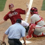 Arizona Diamondbacks' Stephen Drew, top left, is tagged out at the plate by Philadelphia Phillies catcher Carlos Ruiz, top right, as umpire Dale Scott , bottom, looks on in the eighth inning of a baseball game Sunday, April 25, 2010, in Phoenix. (AP Photo/Paul Connors)