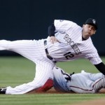 Colorado Rockies second baseman Clint Barmes, top, fails to catch the throw as Arizona Diamondbacks' Chris Young slides safely into second base with a steal during the first inning of a baseball game on Monday, April 26, 2010, in Denver. (AP Photo/David Zalubowski)