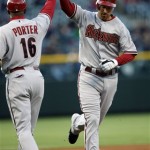 Arizona Diamondbacks' Adam LaRoche, right, is congratulated third base coach Bo Porter as he rounds the bases after hitting a three-run home run against the Colorado Rockies during the first inning of a baseball game on Monday, April 26, 2010, in Denver. (AP Photo/David Zalubowski)