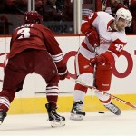 Detroit Red Wings center Darren Helm (43) shoots as Phoenix Coyotes defenseman Keith Yandle (3) defends during the first period of Game 7 of an NHL first-round playoff hockey series Tuesday, April 27, 2010, in Glendale, Ariz. (AP Photo/Ross D. Franklin)