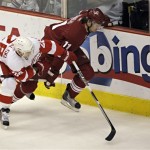 Phoenix Coyotes center Martin Hanzal, right, and Detroit Red Wings defenseman Brian Rafalski race for the puck during the first period of Game 7 of an NHL first-round playoff hockey series, Tuesday, April 27, 2010, in Glendale, Ariz. (AP Photo/Matt York)