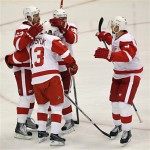 Detroit Red Wings' Pavel Datsyuk (13), Johan Franzen (93), and Nicklas Lidstrom, right, celebrate with teammate Tomas Holmstrom (96) after Holmstrom scored a goal during the second period of Game 7 of an NHL first-round playoff hockey series against the Phoenix Coyotes on Tuesday, April 27, 2010 in Glendale, Ariz. (AP Photo/Ross D. Franklin)
