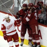 Phoenix Coyotes left wing Vernon Fiddler celebrates his goal with teammate Daniel Winnik (34) as Detroit Red Wings defenseman Brian Rafalski skates by during the second period of Game 7 of an NHL first-round playoff hockey series Tuesday, April 27, 2010, in Glendale, Ariz. (AP Photo/Ross D. Franklin)