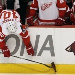 Detroit Red Wings' Henrik Zetterberg (40), of Sweden, tries to pick up a thrown beer bottle off the ice during the third period in Game 7 of a first-round NHL playoff hockey series against the Phoenix Coyotes pm Tuesday, April 27, 2010, in Glendale, Ariz. The Red Wings defeated the Coyotes 6-1, to win the series 4-3. (AP Photo/Ross D. Franklin)
