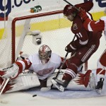 Detroit Red Wings goalie Jimmy Howard stops a shot on goal by Phoenix Coyotes center Martin Hanzal during the third period of Game 7 of an NHL first-round playoff hockey series Tuesday, April 27, 2010, in Glendale, Ariz. The Red Wings won 6-1 to advance to the second round. (AP Photo/Matt York)