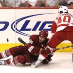 Phoenix Coyotes' Ed Jovanovski (55) and Detroit Red Wings' Henrik Zetterberg (40), of Sweden, get tangled up as they battle for the puck during the third period in Game 7 of a first-round NHL playoff hockey series Tuesday, April 27, 2010, in Glendale, Ariz. The Red Wings defeated the Coyotes 6-1, to win the series 4-3. (AP Photo/Ross D. Franklin)
