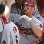 Arizona Diamondbacks' Adam LaRoche celebrates with teammates after hiting a solo home run against the Chicago Cubs during the fifth inning of a baseball game Thursday, April 29, 2010, in Chicago.(AP Photo/Nam Y. Huh)
 